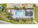 Aerial view of community pool with ample seating, a covered area, and lush landscaping at 43050 Greenway Blvd # 645, Punta Gorda, FL 33982