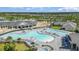 Aerial view of pool area, showcasing lounge chairs, umbrellas, and multiple pool options at 43050 Greenway Blvd # 645, Punta Gorda, FL 33982