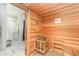 Cedar sauna with a shower room featuring marble tile, bench, and safety warnings posted at 43050 Greenway Blvd # 645, Punta Gorda, FL 33982