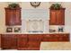 A detailed view of the range area featuring custom woodwork and tile backsplash at 436 Monaco Dr, Punta Gorda, FL 33950