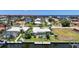 Waterfront home featuring private boat dock, a swimming pool, a screened lanai, and mature tropical landscaping at 48 Hibiscus Dr, Punta Gorda, FL 33950