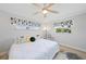 Bright bedroom featuring a ceiling fan, large windows, and a cozy bed with stylish decor at 48 Hibiscus Dr, Punta Gorda, FL 33950
