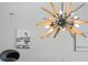 Statement chandelier with wood and metal finishes at 48 Hibiscus Dr, Punta Gorda, FL 33950