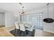 Dining room with seating for six, unique starburst light fixture, and a decorative room divider at 48 Hibiscus Dr, Punta Gorda, FL 33950
