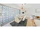 Dining room with a modern chandelier, a sleek table setting, and unique window design at 48 Hibiscus Dr, Punta Gorda, FL 33950