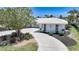 Beautiful house exterior with a well manicured yard and a white tiled roof at 48 Hibiscus Dr, Punta Gorda, FL 33950