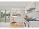 Bright kitchen featuring white cabinets, classic appliances, and a view to the pool at 48 Hibiscus Dr, Punta Gorda, FL 33950