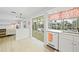 Bright and airy kitchen with retro appliances, white cabinets, and a view to the patio at 48 Hibiscus Dr, Punta Gorda, FL 33950
