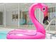 A vivid flamingo float in a pool, with a covered patio and blue chairs visible in the background at 48 Hibiscus Dr, Punta Gorda, FL 33950