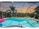 Lovely pool in screened lanai offers a serene waterfront view at sunset with relaxing space for outdoor enjoyment at 48 Hibiscus Dr, Punta Gorda, FL 33950