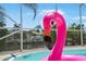 A pink flamingo in the pool with a view to the water at 48 Hibiscus Dr, Punta Gorda, FL 33950