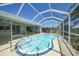 Sparkling pool with a cute pink flamingo floatie is enclosed in a screened lanai for outdoor fun and relaxation at 48 Hibiscus Dr, Punta Gorda, FL 33950