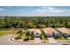Aerial view of a home with lush landscaping, tile roof and brick driveway, highlighted by a red circle at 4992 Brittain Way, North Port, FL 34287