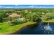 Aerial view featuring the community pool, a serene lake with a fountain, and surrounding lush landscaping at 4992 Brittain Way, North Port, FL 34287