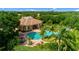 Aerial view of a beautiful home, showcasing a backyard pool, a lush landscape, and the property's overall appeal at 4992 Brittain Way, North Port, FL 34287