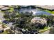 Aerial view of a community featuring a pool and sun deck, surrounded by trees and a pond at 4992 Brittain Way, North Port, FL 34287