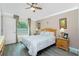 Comfortable bedroom with ceiling fan, ensuite bathroom, and serene natural light at 4992 Brittain Way, North Port, FL 34287