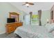 Comfortable bedroom with ceiling fan, ensuite bathroom, and serene natural light at 4992 Brittain Way, North Port, FL 34287