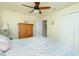 This bedroom features a ceiling fan and ample closet space for storage at 4992 Brittain Way, North Port, FL 34287