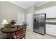 Breakfast nook featuring stainless steel refrigerator and white cabinets at 4992 Brittain Way, North Port, FL 34287