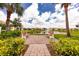 Scenic community park with benches overlooking a tranquil pond and lush landscaping under a cloudy sky at 4992 Brittain Way, North Port, FL 34287