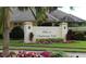 The Villas at Charleston Park entrance sign surrounded by colorful flowers, and a lush landscape at 4992 Brittain Way, North Port, FL 34287