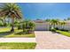 Charming single-story home boasts a well-manicured lawn, brick driveway, and a two-car garage at 4992 Brittain Way, North Port, FL 34287