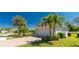 Well-maintained single-story home featuring lush landscaping and a brick-paved driveway leading to a two-car garage at 4992 Brittain Way, North Port, FL 34287