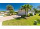 Well-manicured lawn and brick drive leads to single story home with attached garage at 4992 Brittain Way, North Port, FL 34287