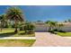 Inviting home exterior with well-maintained landscaping, paver driveway, and a two-car garage at 4992 Brittain Way, North Port, FL 34287