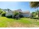 Home exterior with well-manicured lawn and lush tropical landscaping, enhancing its curb appeal at 4992 Brittain Way, North Port, FL 34287