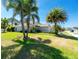 Charming home exterior with well-manicured lawn and lush tropical landscaping, creating curb appeal at 4992 Brittain Way, North Port, FL 34287