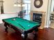 Spacious game room with a pool table, hardwood floors, and a fireplace; perfect for entertaining Gathering and friends at 4992 Brittain Way, North Port, FL 34287