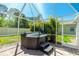 Screened in hot tub with privacy and steps for easy access on a brick patio at 4992 Brittain Way, North Port, FL 34287