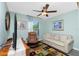 Living room with ceiling fan, comfortable seating, and an abundance of natural light at 4992 Brittain Way, North Port, FL 34287
