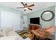 Cozy living room with a ceiling fan, comfortable seating, and an entertainment center at 4992 Brittain Way, North Port, FL 34287