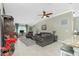 Comfortable living room featuring tile floors, a ceiling fan, and a cozy seating area with leather furniture at 4992 Brittain Way, North Port, FL 34287