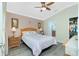 Comfortable main bedroom featuring a ceiling fan and a view into the ensuite bathroom at 4992 Brittain Way, North Port, FL 34287