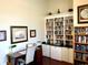 Well-lit home office featuring built-in bookcases and a dark wood desk at 4992 Brittain Way, North Port, FL 34287