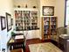 Well-lit home office featuring built-in bookcases and a comfy armchair at 4992 Brittain Way, North Port, FL 34287