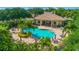 Relaxing community pool area featuring lush landscaping and ample seating; perfect for enjoying the outdoors at 4992 Brittain Way, North Port, FL 34287