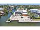 Aerial view of a home and canal, featuring a screened-in pool, boat dock, and rock landscaping at 5181 Sandy Shore Ave, Sarasota, FL 34242