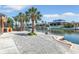 Waterfront backyard featuring a private dock, canal views, and mature palm trees for shade and curb appeal at 5181 Sandy Shore Ave, Sarasota, FL 34242