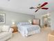 Bright bedroom features neutral walls, a ceiling fan, and a comfortable bed with floral bedding at 5181 Sandy Shore Ave, Sarasota, FL 34242