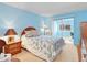 Comfortable blue bedroom featuring sliding glass doors to a patio and nautical themed bedding at 5181 Sandy Shore Ave, Sarasota, FL 34242