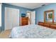 Bright blue bedroom features carpet, large window, and a queen bed with nautical themed bedding at 5181 Sandy Shore Ave, Sarasota, FL 34242