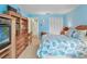 Bedroom features a large bed with nautical themed bedding, a built-in desk, and a closet at 5181 Sandy Shore Ave, Sarasota, FL 34242