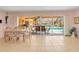 Dining area with views of the screened lanai, pool area, and outdoor seating at 5181 Sandy Shore Ave, Sarasota, FL 34242