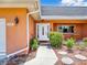 Inviting entryway with stylish landscaping and a decorative water fountain adding charm to the home's exterior at 5181 Sandy Shore Ave, Sarasota, FL 34242