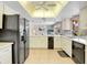 Open-concept kitchen featuring white cabinets and black appliances at 5181 Sandy Shore Ave, Sarasota, FL 34242